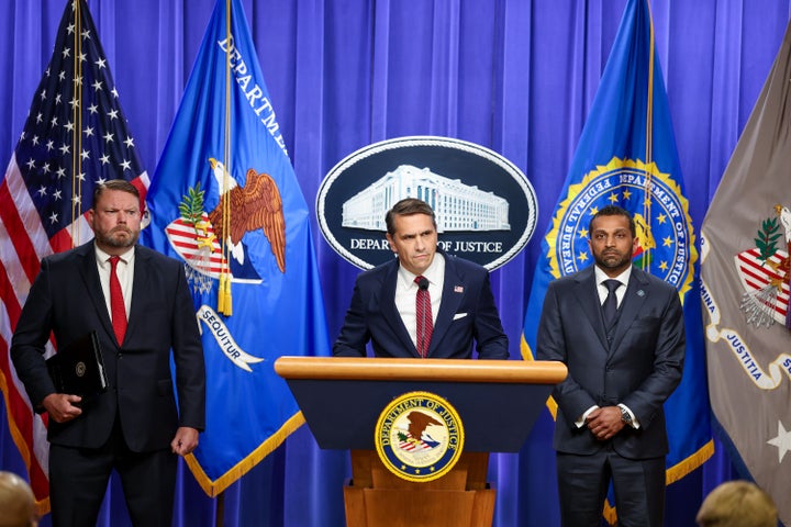 WASHINGTON, DC - APRIL 28: Acting Attorney General Todd Blanche speaks as Ellis Boyle, United States Attorney for the Eastern District of North Carolina (L) and FBI Director Kash Patel listen at a press conference on April 28, 2026 at the Department of Justice in Washington, DC. Charges were brought against former FBI Director James Comey on Tuesday in an investigation over a photo of seashells arranged on a beach posted to social media, that officials said constituted a threat against President Donald Trump. (Photo by Tasos Katopodis/Getty Images)