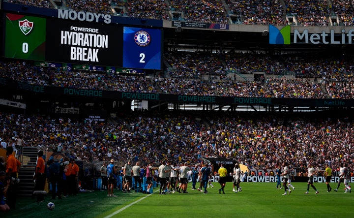 Fluminense and Chelsea players take a hydration break during the second half of a Club World Cup soccer semi-final match in East Rutherford, New Jersey, in July 2025.