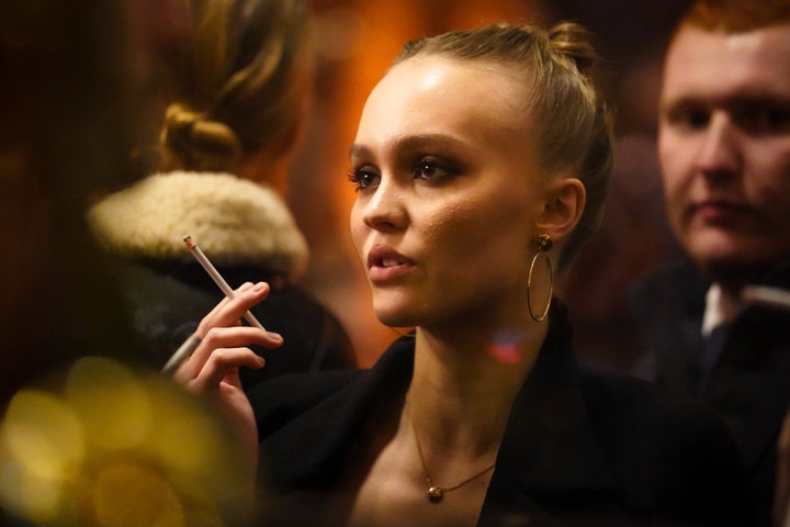 Actor Lily-Rose Depp smokes outside La Coupole restaurant in Paris.