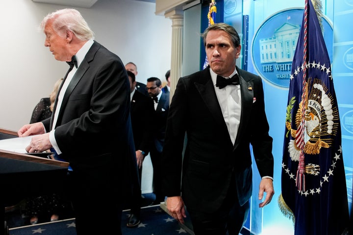 Acting Attorney General Todd Blanche looks over at President Donald Trump at a news conference Saturday.