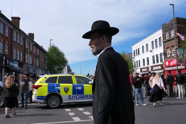 People gather at a road block after two people were stabbed in Golders Green neighbourhood, that has a large Jewish community, in London, Wednesday, April 29, 2026.