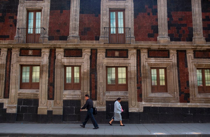 Pedestrians walk past a slightly tilted historic building in downtown Mexico City, June 15, 2016. (AP Photo/Rebecca Blackwell, File)