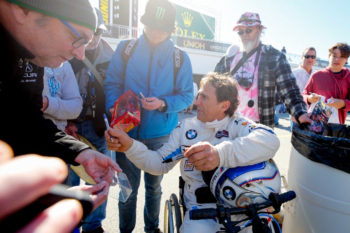 Alex Zanardi, driver of the #24 BMW Team RLL BMW M8 GTE signs autographs for fans practicing for the Rolex 24 at Daytona on January 25, 2019 at the Daytona International Speedway in Daytona Beach, Florida. (Photo by David Rosenblum/Icon Sportswire via Getty Images)