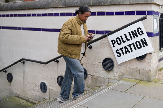 A woman leaves a polling station after voting in 2024