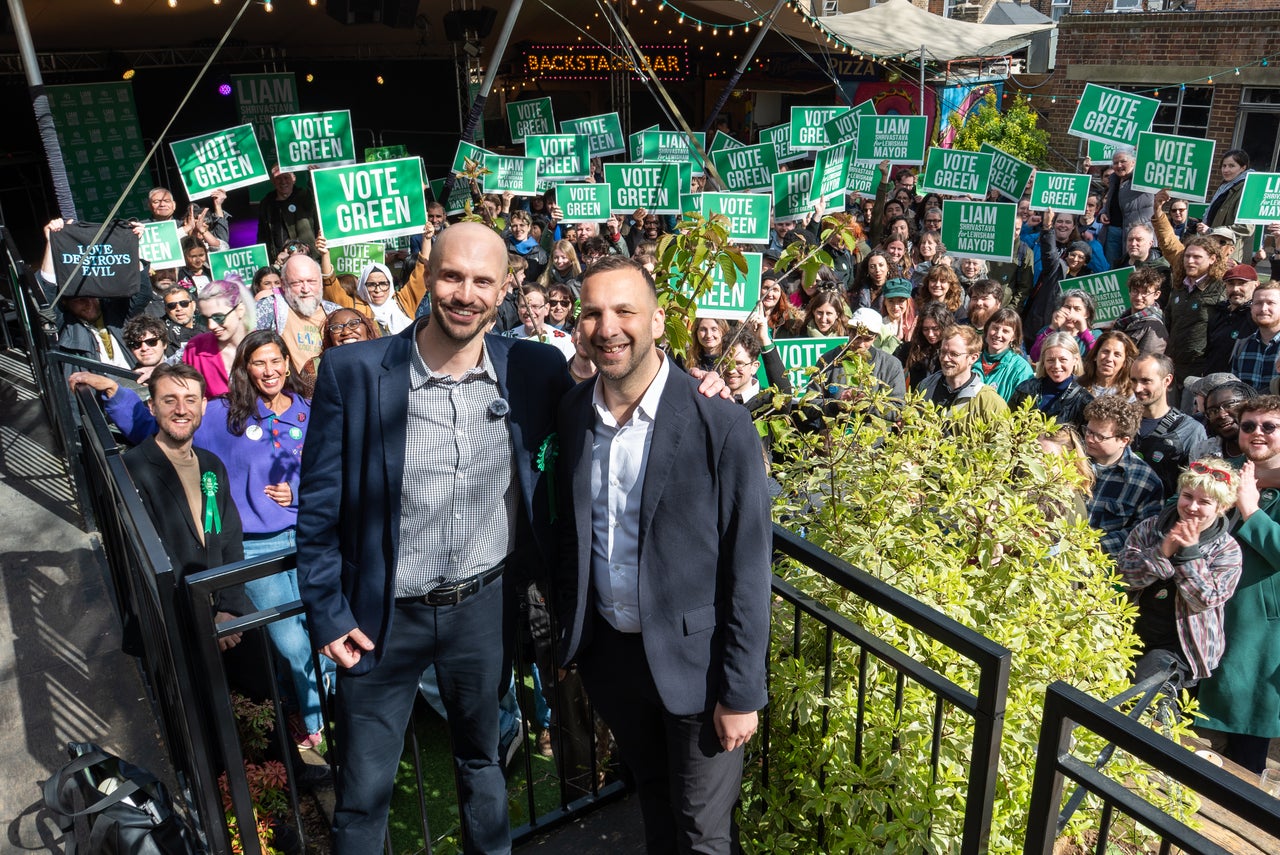 (L-R) Councillor and Green Party candidate for Mayor of Lewisham, Liam Shrivastava and Green Party Leader Zack Polanski pose with supporters holding placards during Lewisham Green Party's 'Big Day Out' at the Fox and Firkin on April 11, 2026