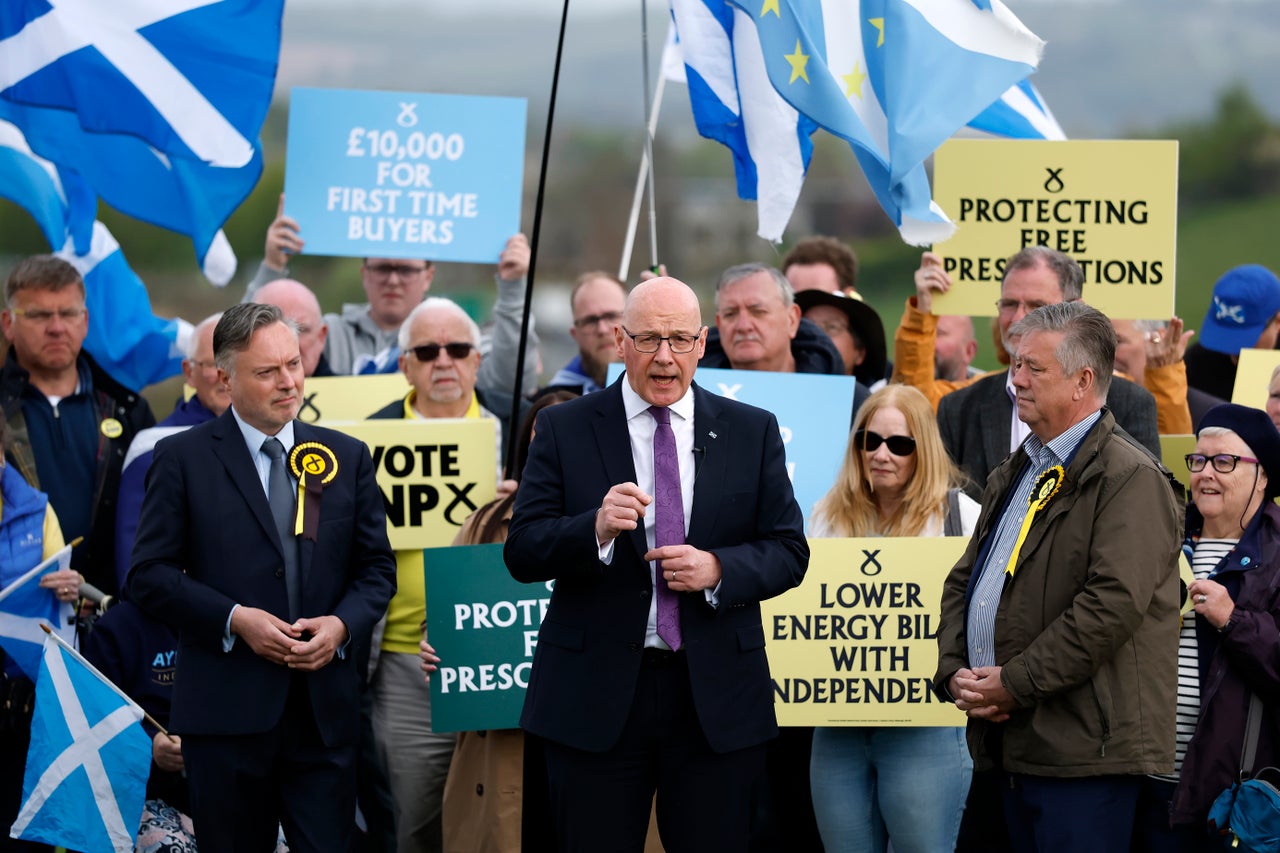 SNP MSP Candidate for Stirling Alyn Smith (C-L), First Minister John Swinney (C) and Deputy Leader of the SNP Keith Brown (C-R) pose for a photo after a campaign stump speech at the King's Knot on May 01, 2026