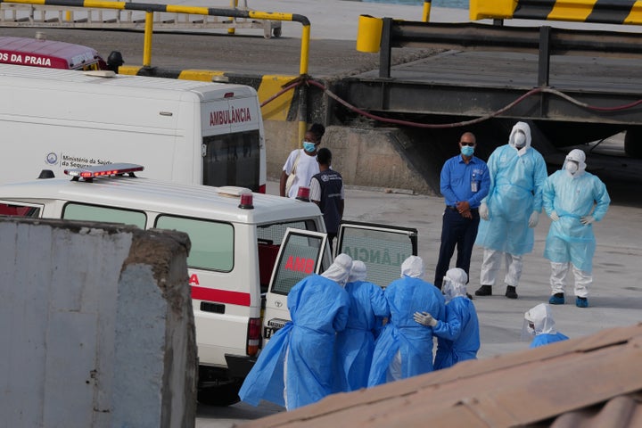 Health workers in protective gear evacuate patients from the MV Hondius cruise ship into an ambulance at a port in Praia, Cape Verde, Wednesday, May 6, 2026. (AP Photo/Misper Apawu)