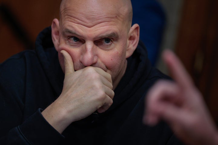 Sen. John Fetterman (D-Pa.) prepares to vote to advance Sen. Markwayne Mullin (R-Okla.) to be secretary of the Department of Homeland Security on March 19, 2026.