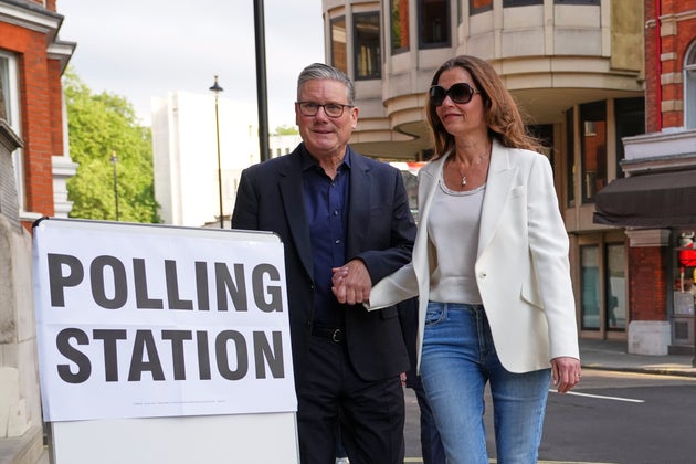 Keir Starmer and wife Victoria arrive at a polling station in central London.