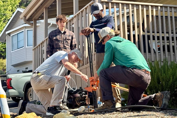 Scientists take samples from the soil Thursday, May 7, 2026, from the neighboring yard of a home in Arroyo Grande, Calif., connected to the man convicted of killing Kristin Smart as part of a sheriff's investigation. (AP Photo/Haven Daley)