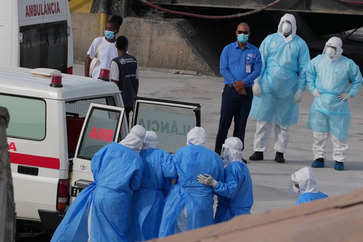 Health workers in protective gear evacuate patients from the MV Hondius cruise ship into an ambulance at a port in Praia, Cape Verde, Wednesday, May 6, 2026. (AP Photo/Misper Apawu)
