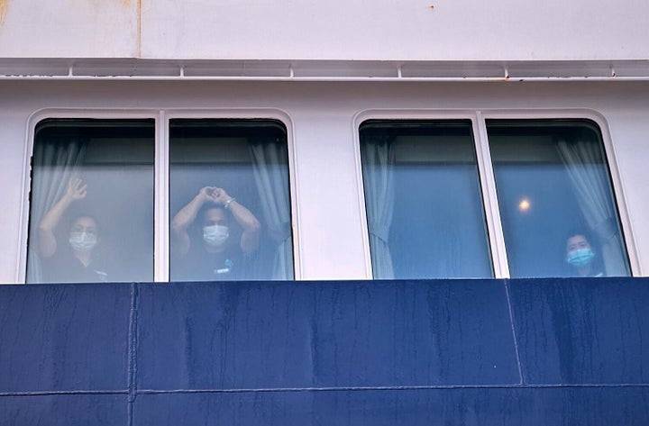 Passengers watch as others disembark from the MV Hondius cruise ship, which contracted hantavirus, at the port of Granadilla in Tenerife, Canary Islands, Spain, Sunday, May 10, 2026. (AP Photo)