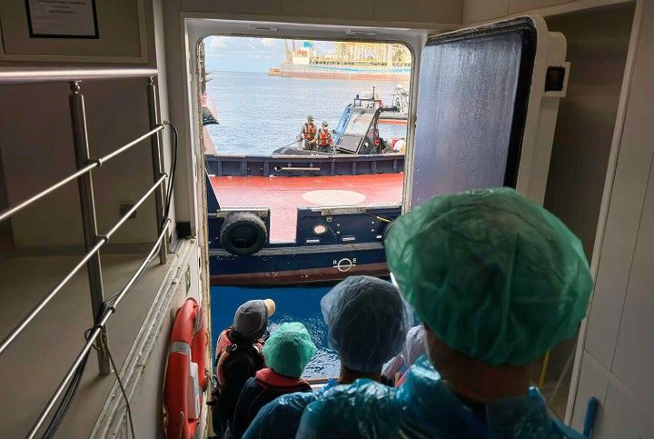 Passengers are disembarked from the MV Hondius cruise ship, which has contracted hantavirus, at the Granadilla port in Tenerife, Canary Islands, Spain, Sunday, May 10, 2026. (AP Photo)