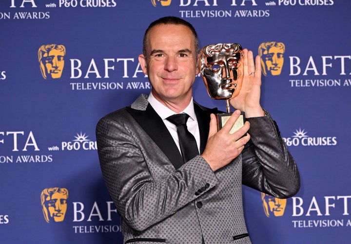 Martin Lewis posing with this Bafta