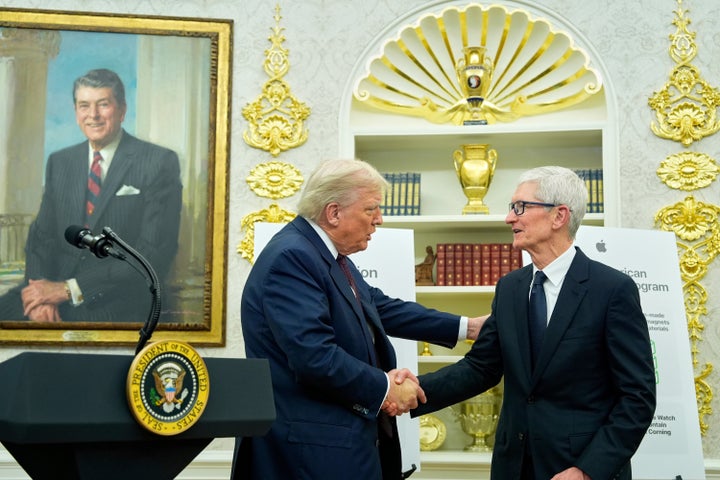President Donald Trump shakes hands with Apple CEO Tim Cook in the Oval Office, Wednesday, Aug. 6, 2025, in Washington. (AP Photo/Alex Brandon)