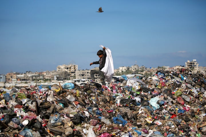 A Palestinian child sifts through rubbish at the Nuseirat refugee camp in central Gaza on May 7, 2026. Despite the October ceasefire, Gaza remains gripped by daily violence as Israeli strikes continue, with both the military and Hamas accusing one another of violating the truce.