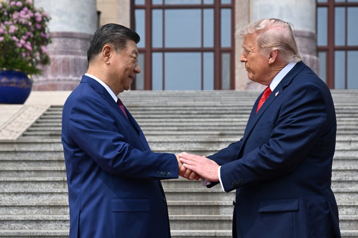 Above, President Donald Trump shakes hands with China's President Xi Jinping at the Great Hall of the People in Beijing.