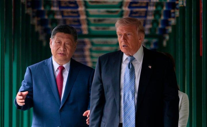 U.S. President Donald Trump participates in a friendship walk through Zhongnanhai Garden with Chinese President Xi Jinping in Beijing, Friday, May 15, 2026. (Evan Vucci/Pool Photo via AP)