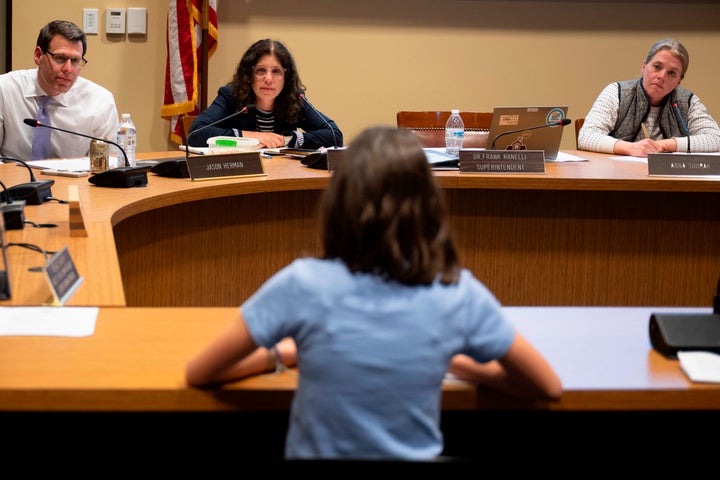 Members of the Lower Merion Board of School Directors speak with a student at a school board meeting on Monday, May 11, 2026, in Ardmore, Pennsylvania.