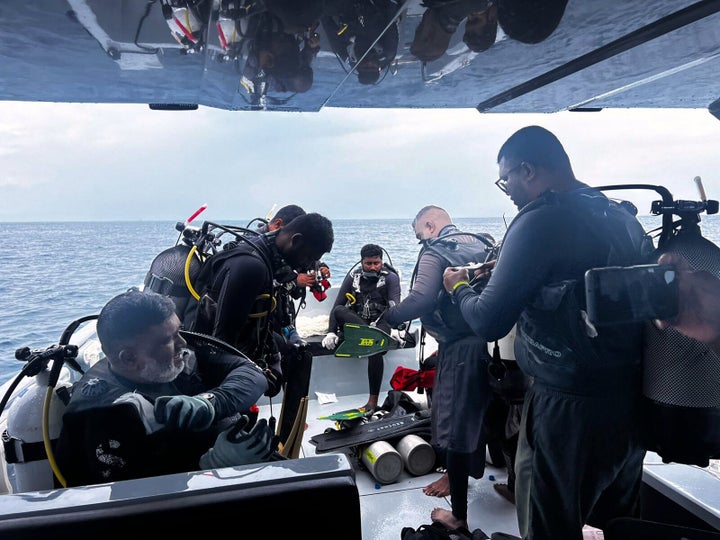 This image released by the Media Division of the President of the Maldives shows divers preparing to search for four missing Italian divers near Alimathaa Island, Vaavu Atoll, Maldives, on Saturday, May 15, 2026. (Maldives President's Media Division, via AP)