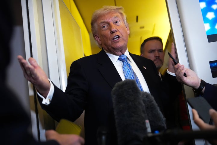 President Donald Trump speaks to reporters aboard Air Force One, Friday, May 15, 2026, as he returns from a trip to Beijing, China. (AP Photo/Mark Schiefelbein)