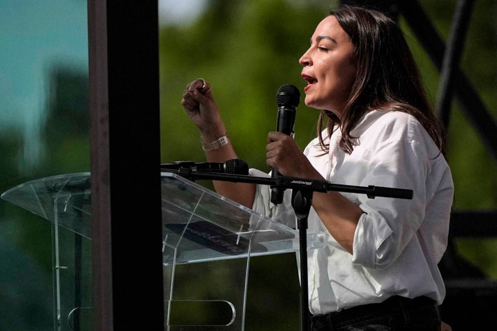 U.S. Rep. Alexandria Ocasio-Cortez, D-N.Y., speaks from behind a bullet resistant glass during a voting rights rally, Saturday, May 16, 2026, in Montgomery, Ala. (AP Photo/Mike Stewart)