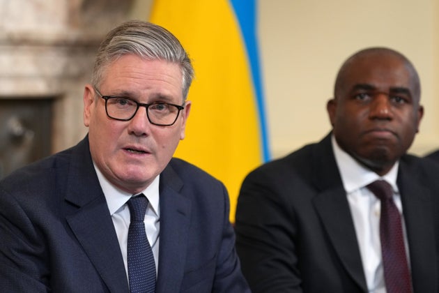 Britain's Prime Minister Keir Starmer sits beside David Lammy, Deputy Prime Minister, as he delivers remarks at the top of the Cabinet meeting to mark the fourth anniversary of Russia's full-scale invasion of Ukraine at Downing Street in London, Tuesday, Feb. 24, 2026.