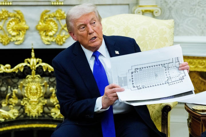 Trump holds a floor plan of the planned White House ballroom extension on Oct. 22, 2025.