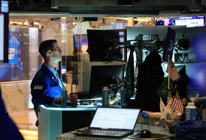 A trader works at his desk on the floor of the New York Stock Exchange (NYSE) in New York on May 19, 2026. Wall Street stocks retreated early Tuesday as analysts pointed to angst over inflation pressures as the prolonged Middle East war kept oil prices high. (Photo by TIMOTHY A. CLARY / AFP via Getty Images)