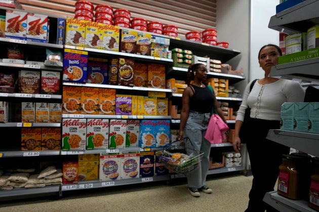 Shoppers buy food in a supermarket in London, Wednesday, Aug. 17, 2022.