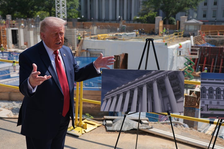 Trump talks to reporters last week about the columns for proposed White House ballroom next to the worksite.