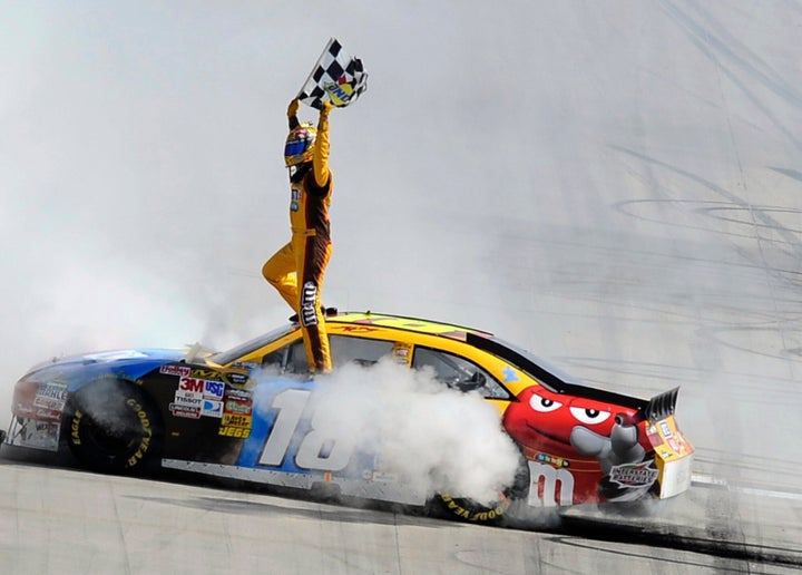 Kyle Busch celebrates his win in the NASCAR Sprint Cup Series' Autism Speaks 400 auto race in 2010.