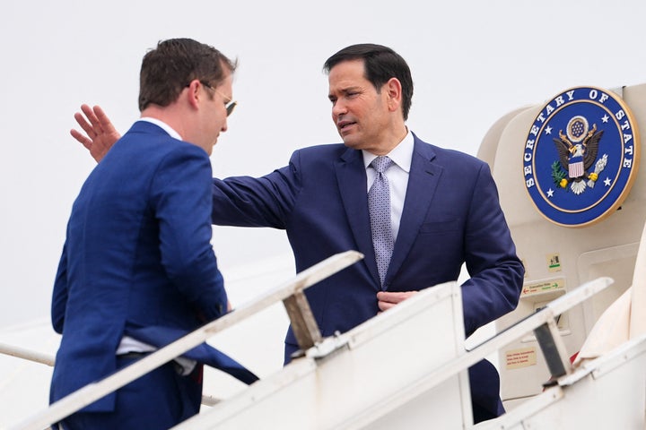 US Secretary of State Marco Rubio (R) waves as he boards his plane for New Delhi with the US Ambassador to India Sergio Gor at Netaji Subhash Chandra Bose International Airport in Kolkata on May 23, 2026. Rubio arrived May 23 on his first trip to India where he will meet Prime Minister Narendra Modi on the heels of US diplomacy with China. (Photo by Julia Demaree Nikhinson / POOL / AFP via Getty Images)