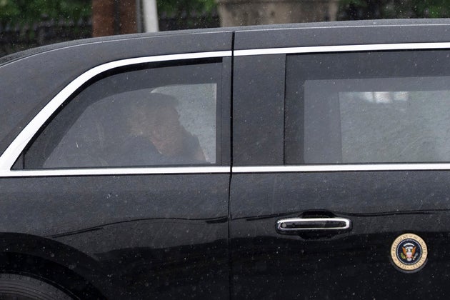 President Donald Trump sits at the back of the presidential limousine as it drives outside the Walter Reed National Military Medical Center from the White House on May 15, in Bethesda, Maryland.