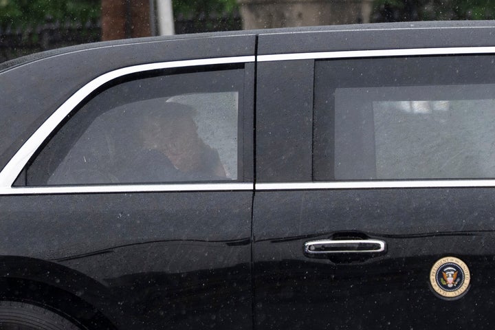 President Donald Trump sits at the back of the presidential limousine as it drives outside the Walter Reed National Military Medical Center from the White House on May 15, in Bethesda, Maryland.