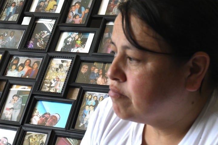 Adriana Garzon, mother of Brayan Rayo Garzon who died by suicide while in ICE custody in April 2025, sits in front of a collection of family photos in St. Louis, Friday, May 1, 2026. (AP Photo/Nick Ingram)