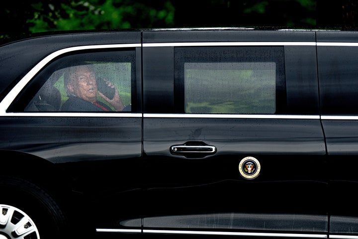 President Donald Trump speaks on the phone as he returns to the White House on Monday.