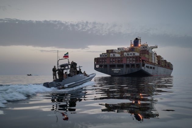 In this photo released by Tasnim News Agency, a Revolutionary Guard Navy (IRGC) speedboat approaches the cargo ship Epaminondas during what state media described as the seizure of one of two vessels accused of violations in the Strait of Hormuz on April 21.