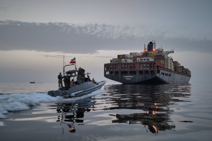 In this photo released by Tasnim News Agency, a Revolutionary Guard Navy (IRGC) speedboat approaches the cargo ship Epaminondas during what state media described as the seizure of one of two vessels accused of violations in the Strait of Hormuz on April 21.