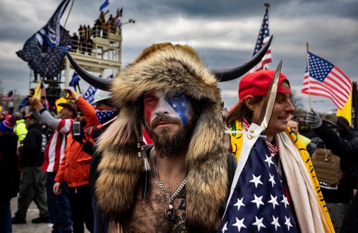 Jacob Anthony Angeli Chansley, known as the QAnon Shaman, is seen at the Capital riot. He was arrested on federal charges of "knowingly entering or remaining in any restricted building or grounds without lawful authority, and with violent entry and disorderly conduct on Capitol grounds."