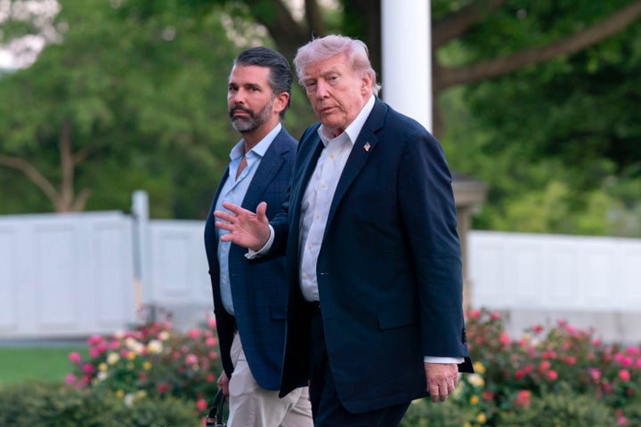 President Donald Trump and Donald Trump Jr. walk on the South Lawn upon their arrival to the White House, Sunday, May 3, 2026, in Washington. (AP Photo/Jose Luis Magana)