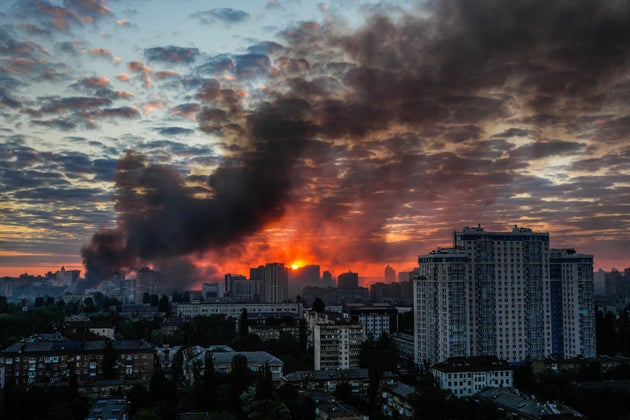 Smoke raises above the city in sunrise following an intensive Russian air attack in Kyiv, Ukraine, Sunday, May 24, 2026.