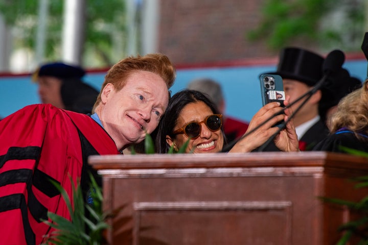 US comedian Conan O'Brien (L), commencement speaker, takes photos with students and faculty in Harvard Yard during the 175th Commencement ceremony at Harvard University in Cambridge, Massachusetts on May 28, 2026. (Photo by Joseph Prezioso / AFP via Getty Images)