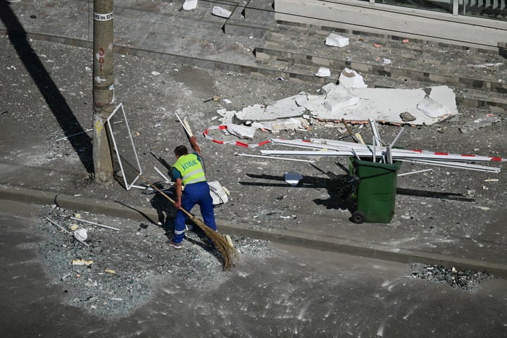 A municipal worker clears debris from the street after a Russian drone struck an apartment building in Galati, eastern Romania. A Russian drone wounded two people as it struck an apartment building in NATO-member Romania, its defence ministry said on May 29, 2026, the latest spillover from the four-year war into neighbouring states. (Photo by Daniel MIHAILESCU / AFP via Getty Images)