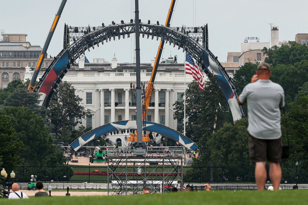 An onlooker photographs ongoing construction for the UFC ring.