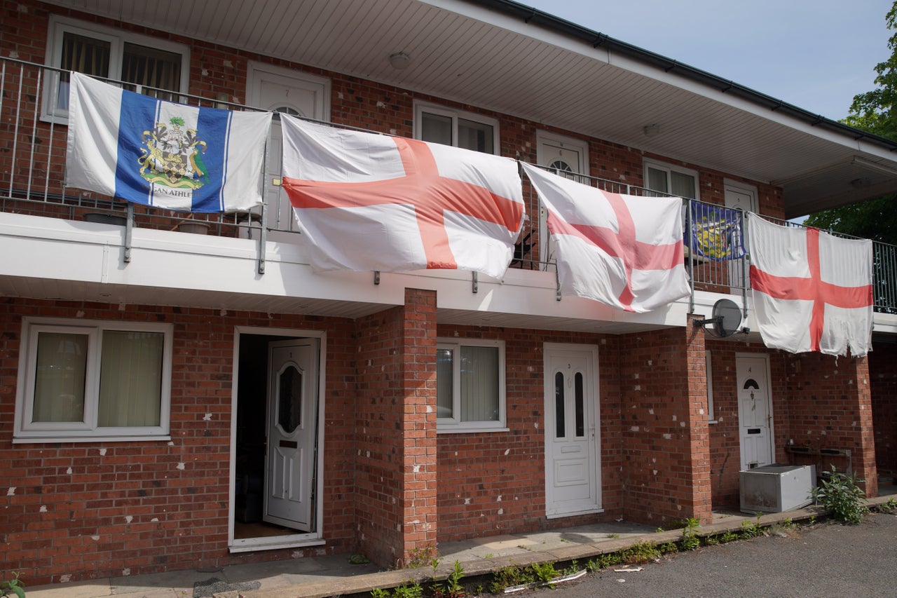 View at flats decorated with the St George's Cross flag in Ashton-in-Makerfield where Andy Burnham will stand as Labour's candidate for the by-election in Makerfield, England, Friday, May 22, 2026.
