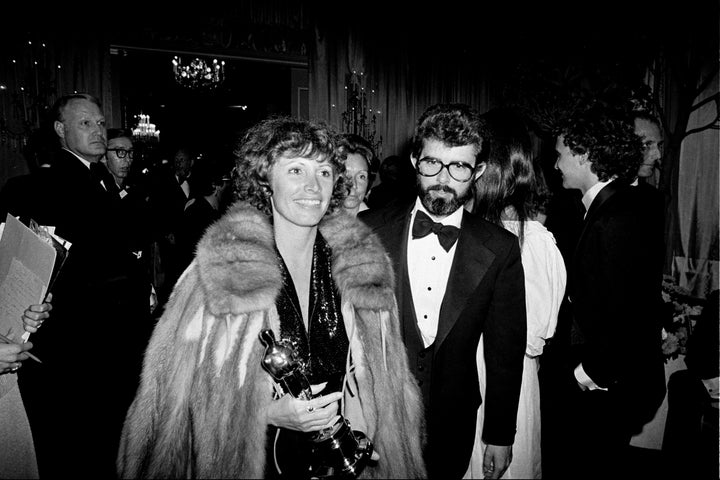 Marcia Lucas, wife of director George Lucas, right, carries her Oscar statuette as they arrive at a post Academy Awards party at the Beverly Hilton Hotel in Los Angeles, April 4, 1978. (AP Photo, File)