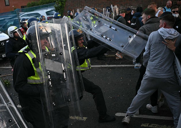 Protestors demonstrate with police officers near Portswood Police Station in Southampton.