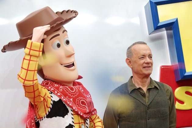 Tom Hanks posing with Woody at the Toy Story 5 launch in London last month