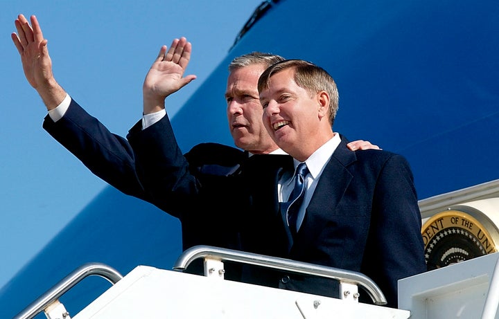 Then-President George W. Bush (left) stands with Rep. Lindsey Graham (R-S.C.) on the steps of Air Force One at the Greenville/Spartanburg Airport in March 2002 in Greenville, South Carolina.
